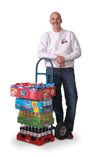 Vending machine operator with drinks on a dolly